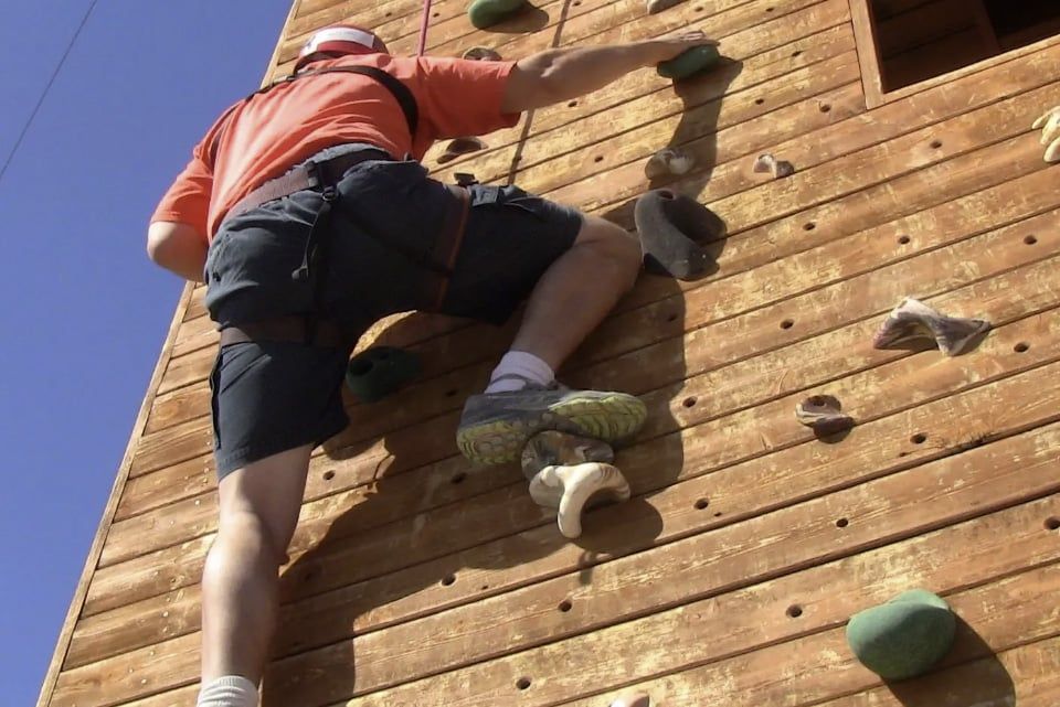 Climbing a wall during a group challenge