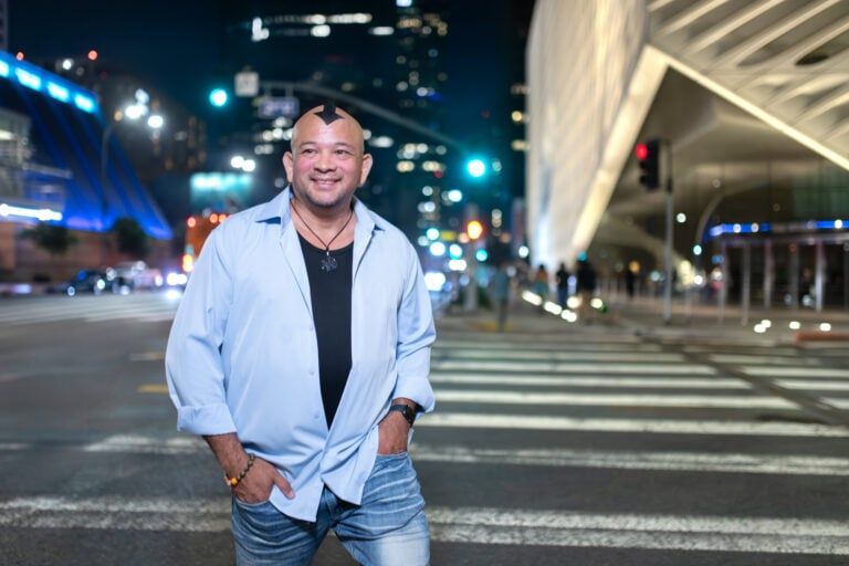 King Kātō standing on a city street at night